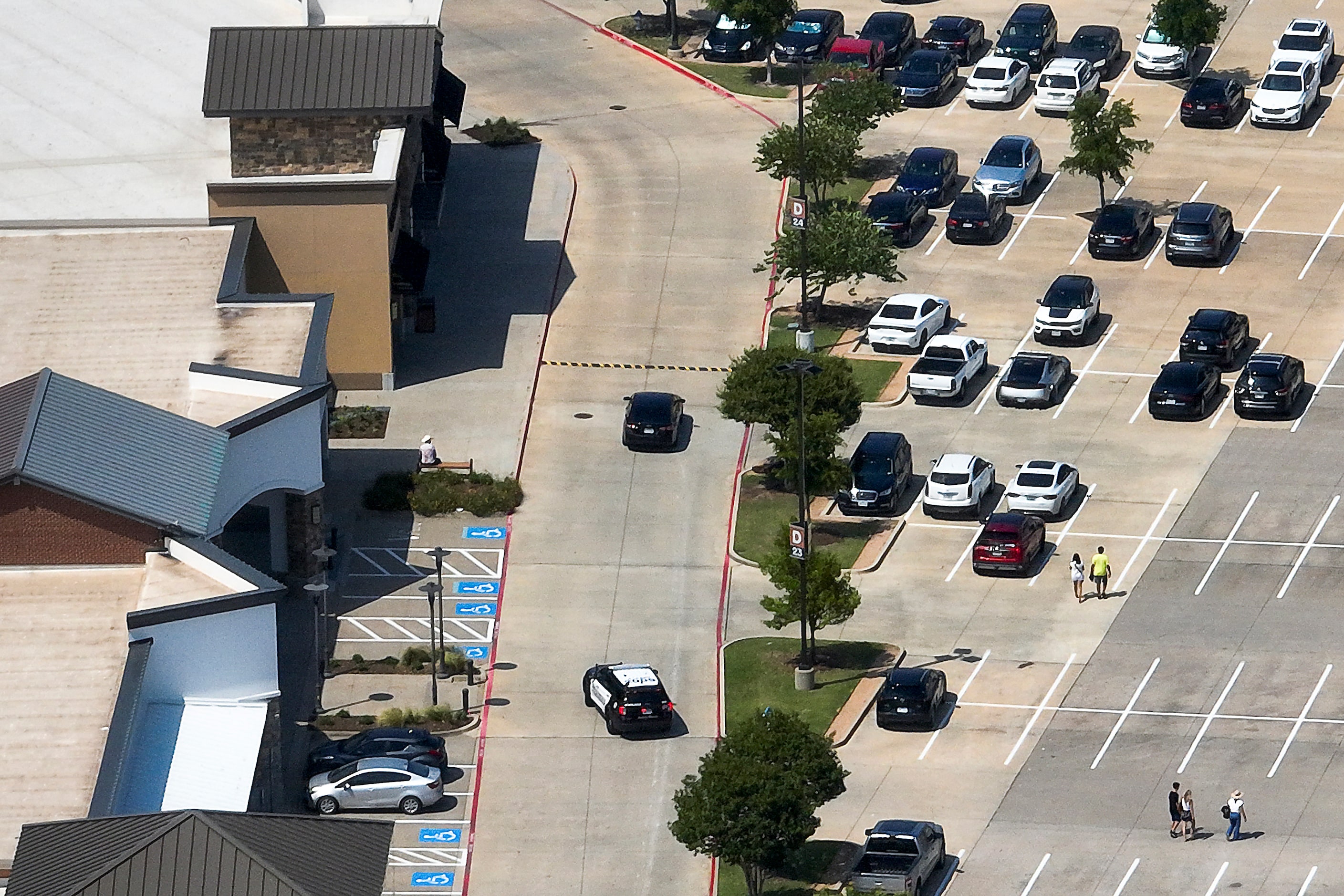 Allen police patrol in front of the H&M store in an aerial view of the Allen Premium Outlets...