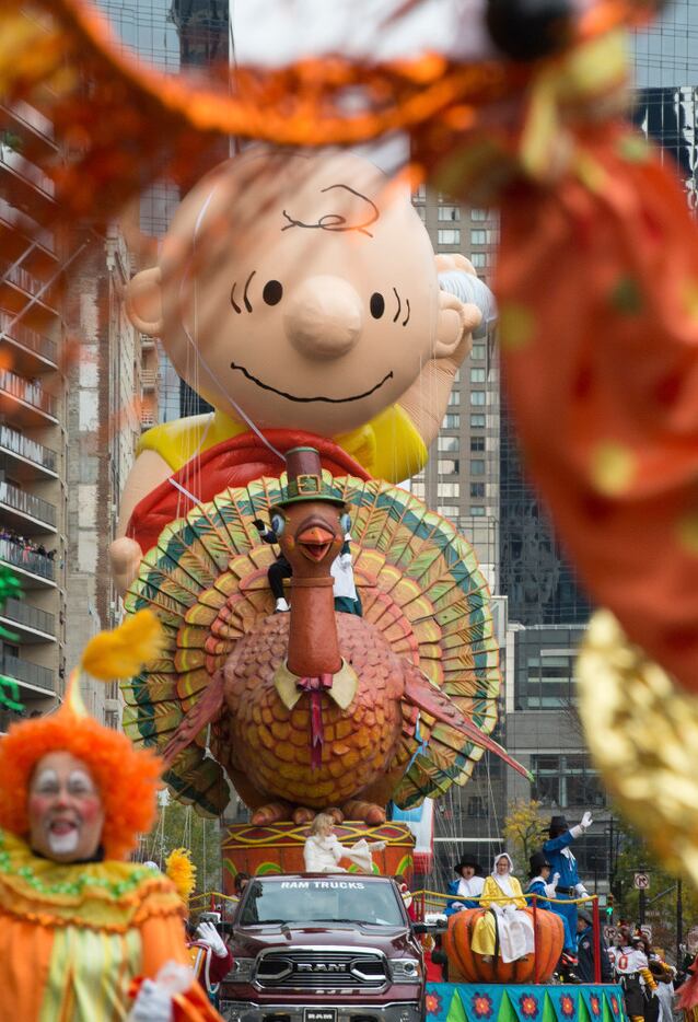 The Turkey float and Charlie Brown balloon move across Central Park South. (AP Photo/Bryan...