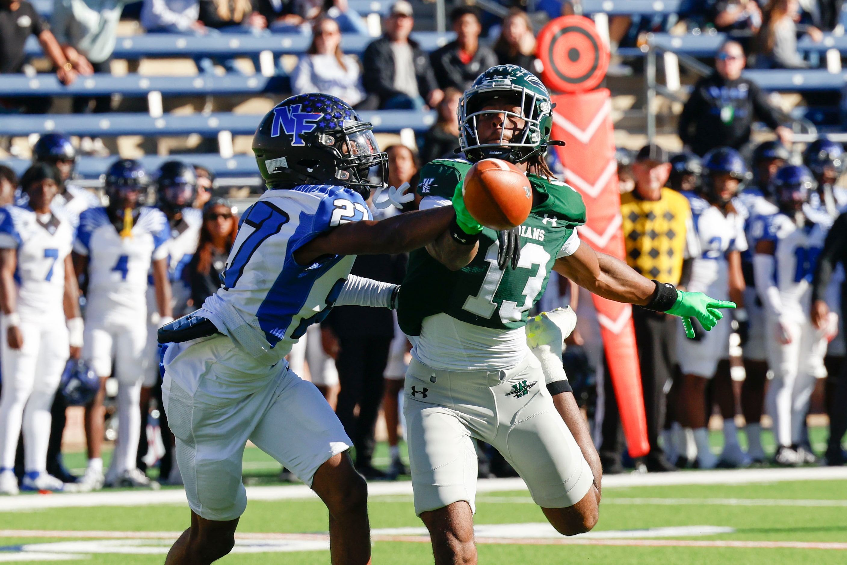 North Forney’s Gianni Edwards (left) breaks up a pass intended for Waxahachie High’s...