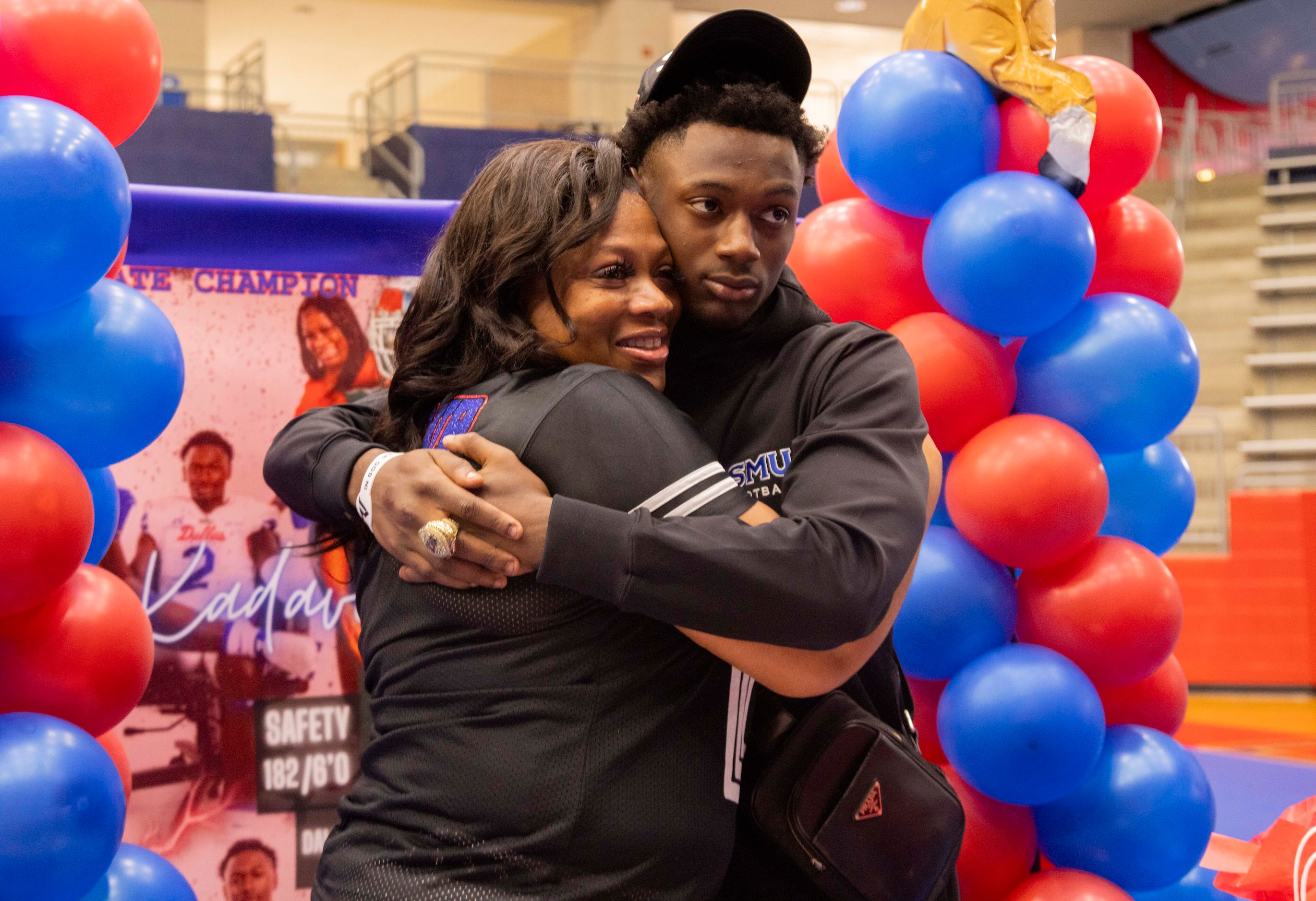 Safety Ka'Davion Dotson-Walker hugs his mom Karen Dotson during photos after signing his...