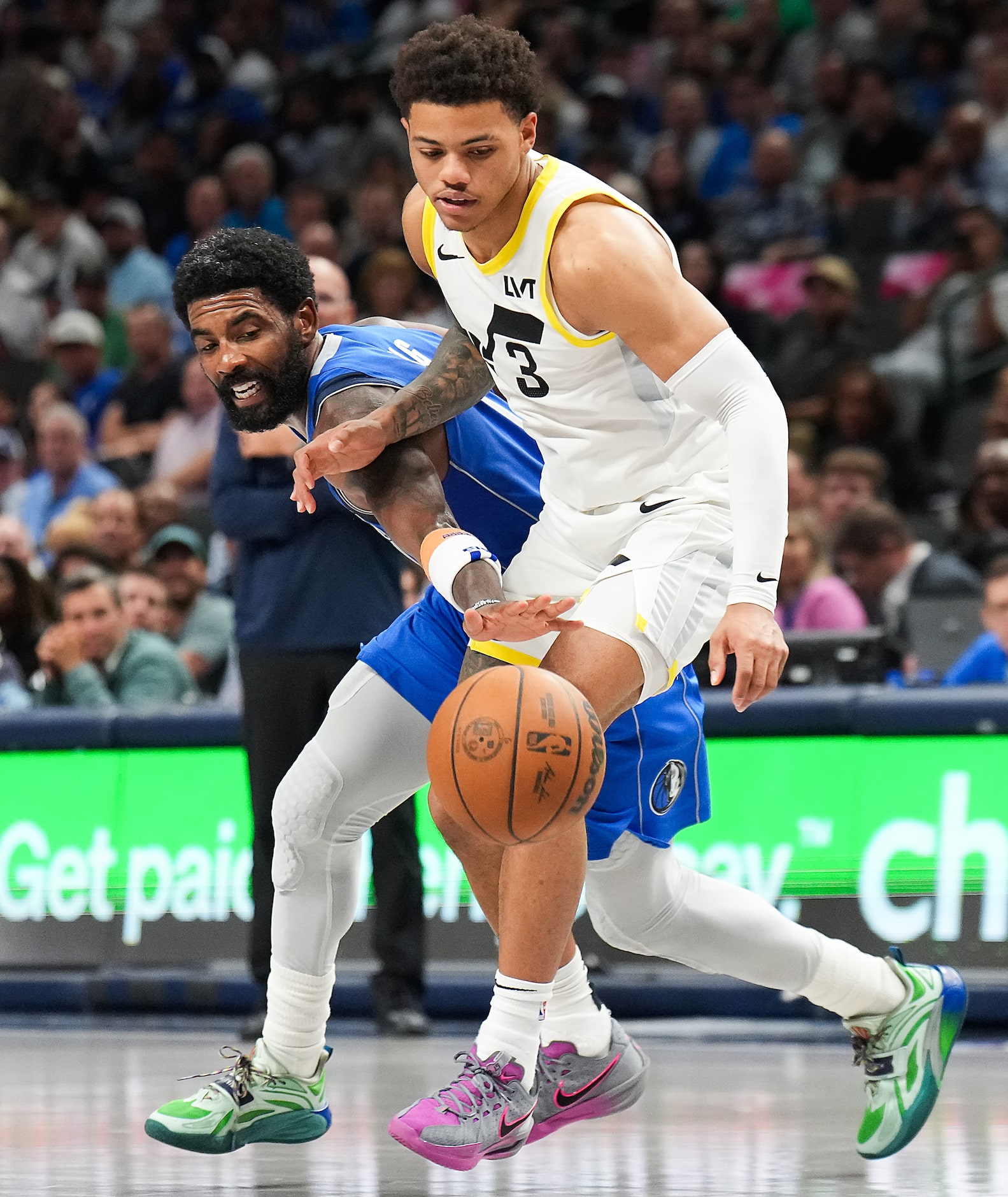 Dallas Mavericks guard Kyrie Irving (11) steals the ball from Utah Jazz guard Keyonte George...