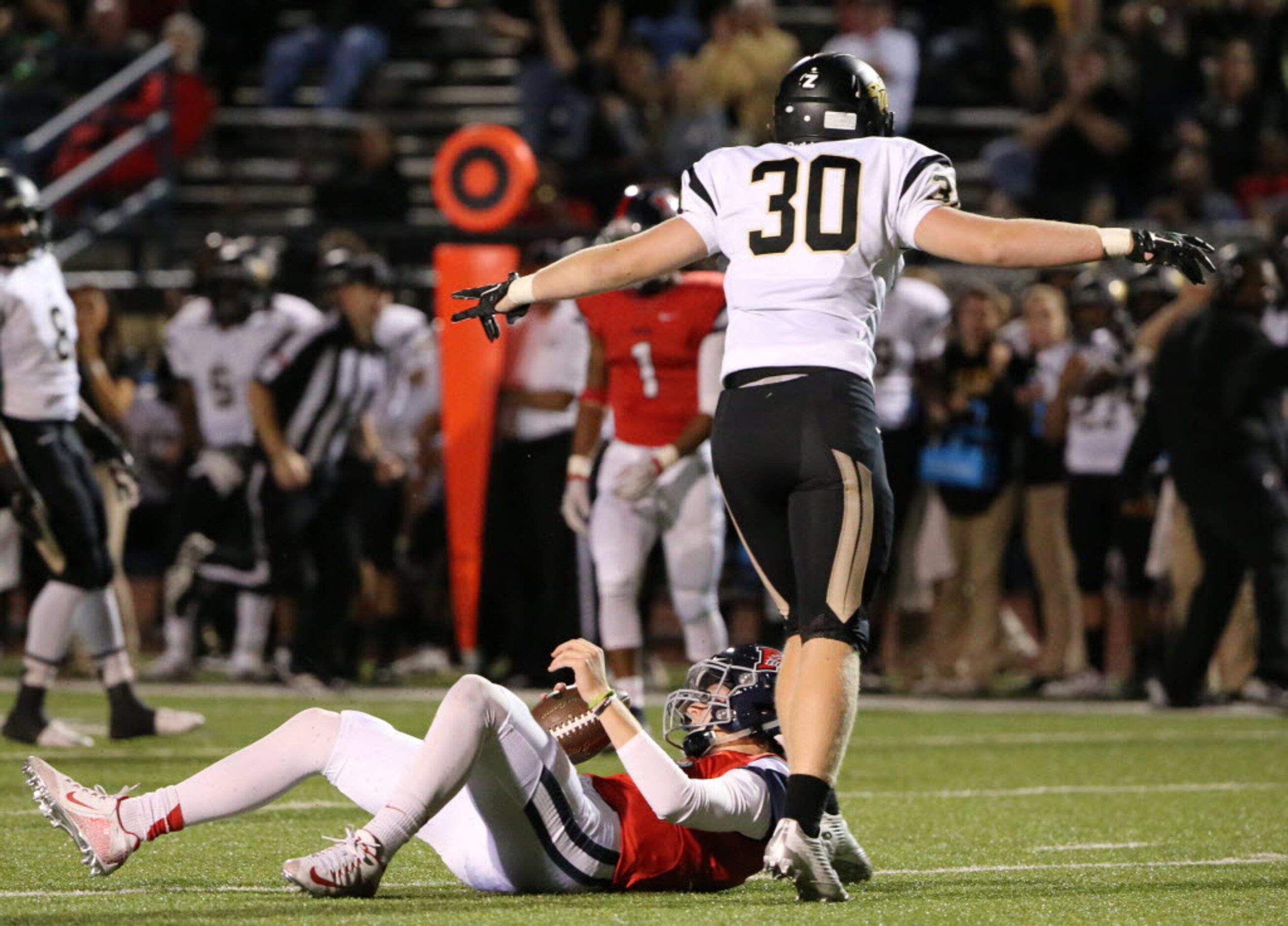 Plano East defensive lineman Grayson Diepenbrock (30) celebrate after sacking McKinney Boyd...