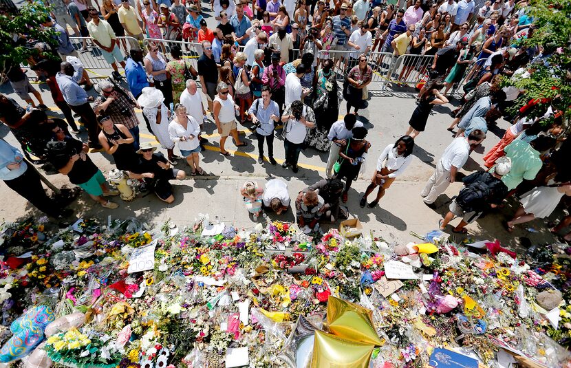 People pay respects outside Emanuel A.M.E. Church during a worship service, Sunday, June 21,...