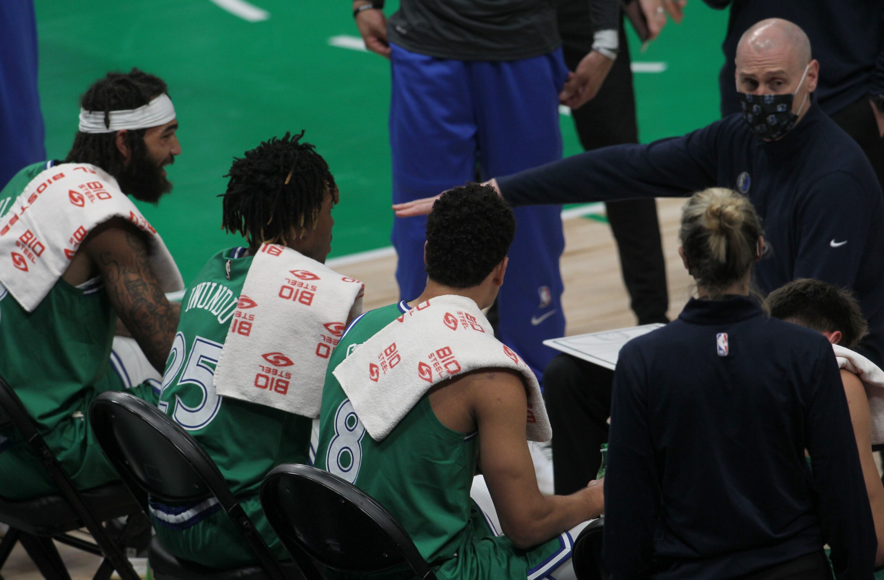 Dallas Mavericks head coach Rick Carlisle has a court-side chat with his players during a...