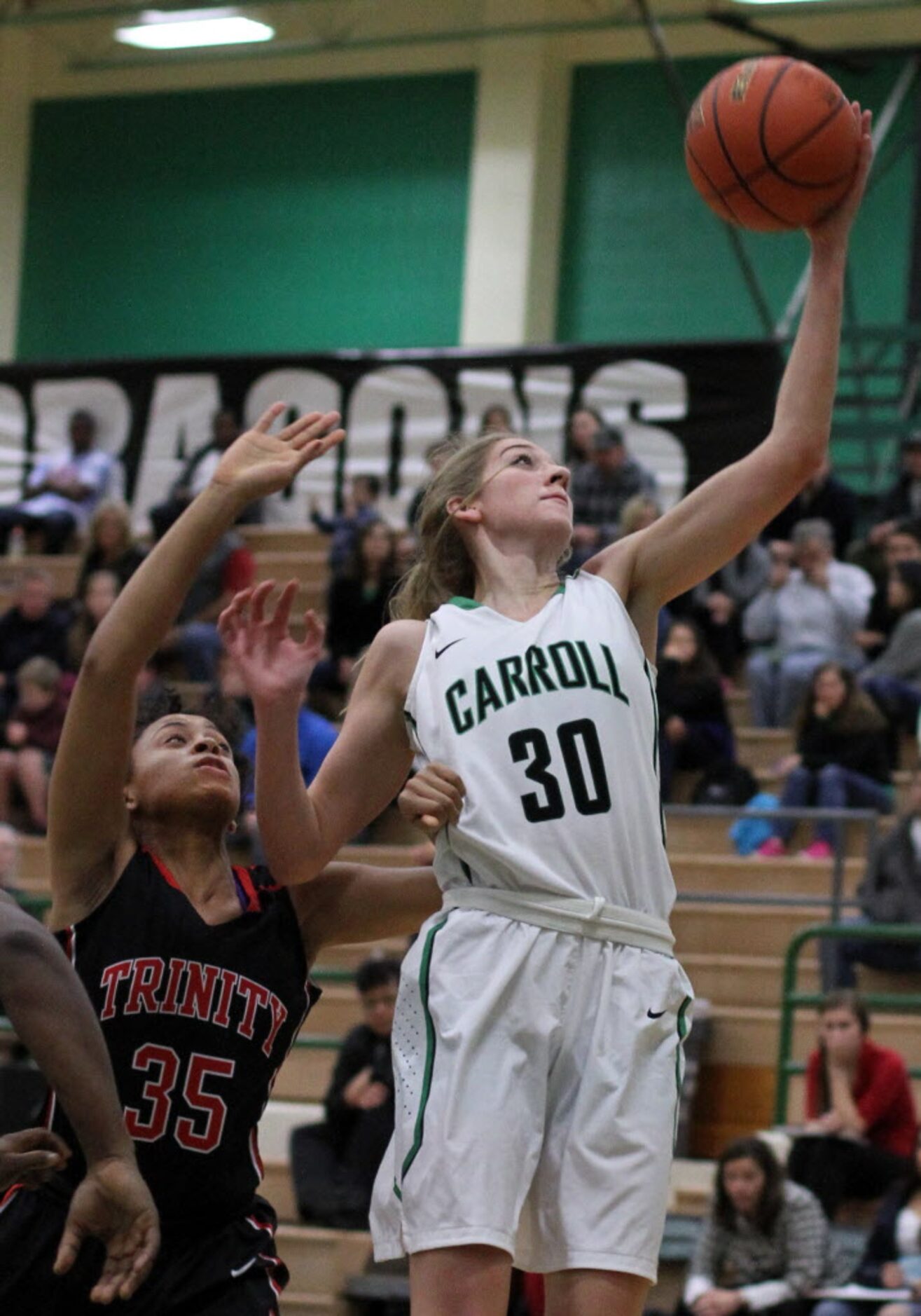 Southlake Carroll's Anna Hurlburt (30) reaches for a lob pass over the defense of Euless...