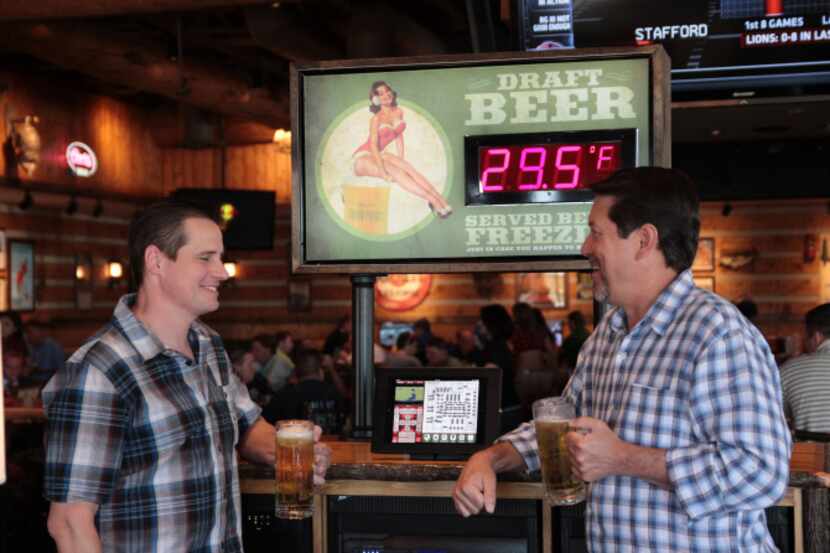 Twin Peaks brewmaster Tom Janik (left) drinks a draft beer with Twin Peaks CEO Randy DeWitt...