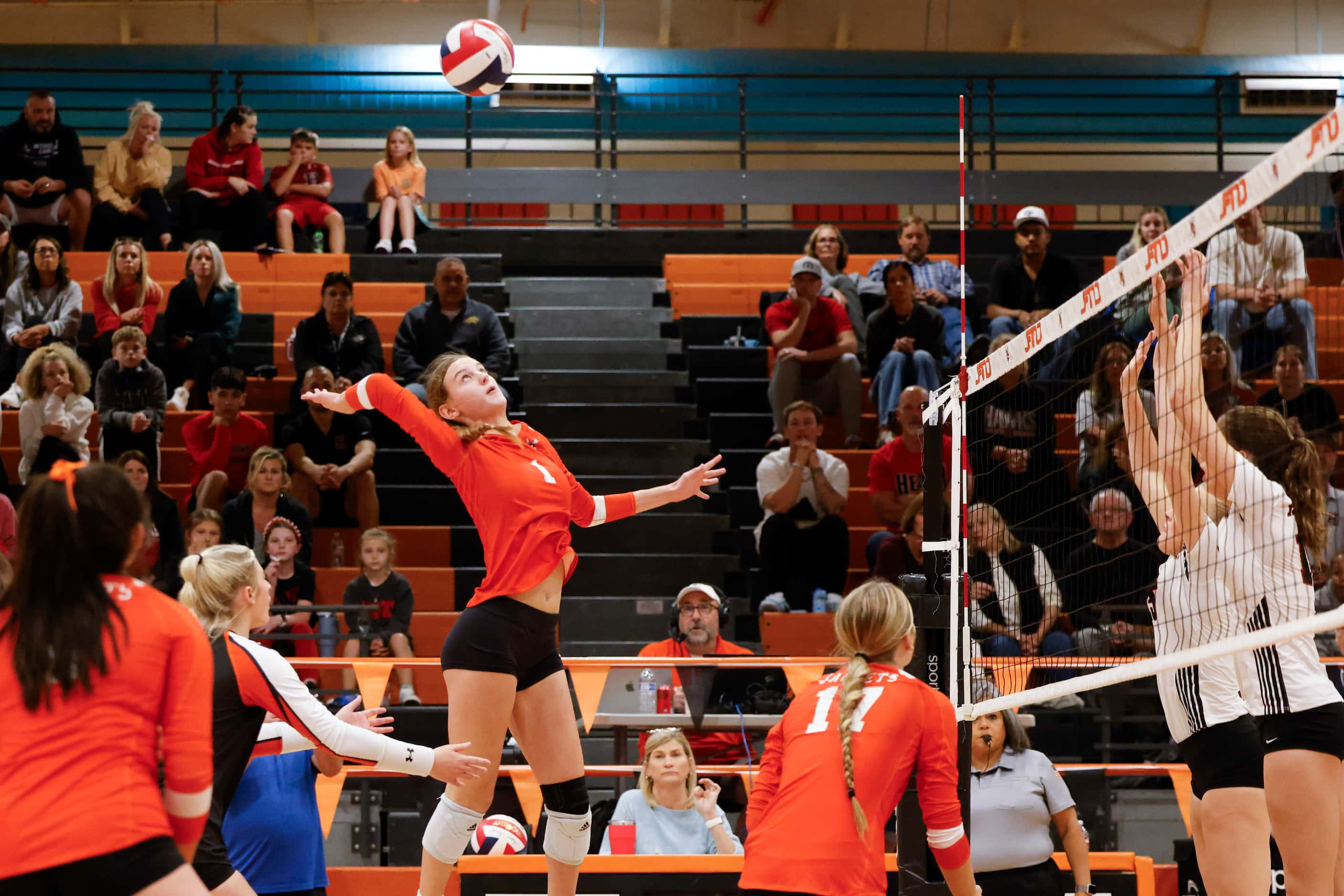 Rockwall high’s Halle Jameson (1) spikes the ball against Rockwall heath during a volleyball...