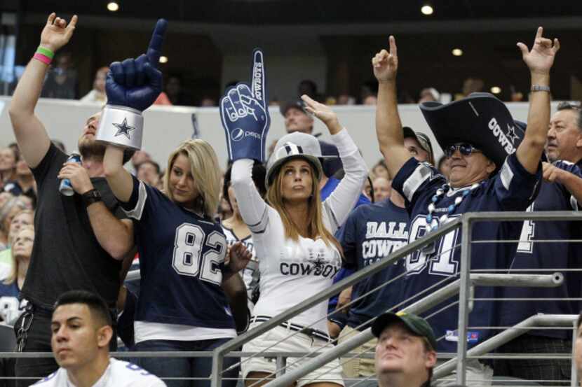 Dallas Cowboys fans celebrate as they watched them defeat the St. Louis Rams during their...