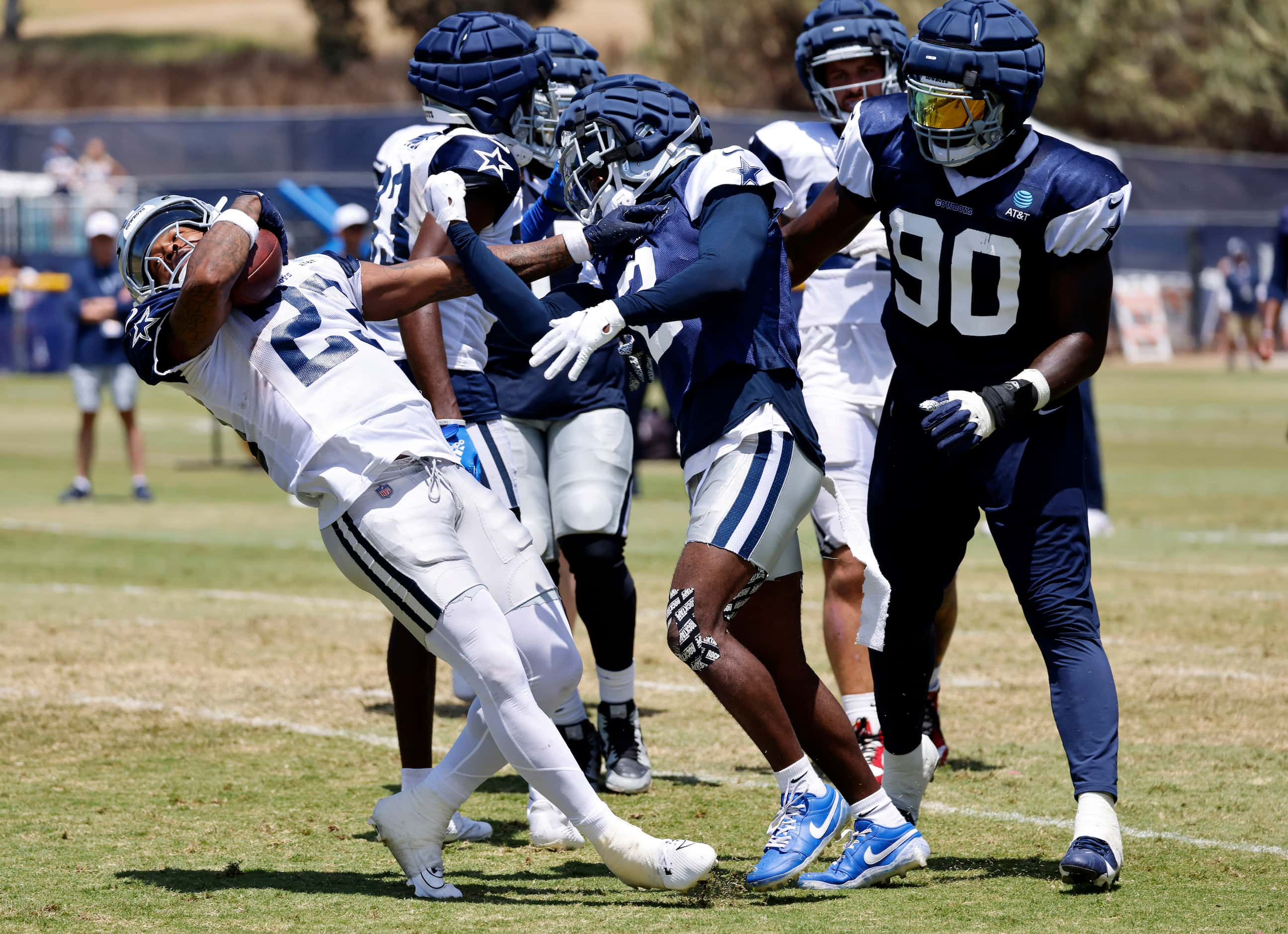 Dallas Cowboys running back Rico Dowdle (23) spins out of a tackle by cornerback Jourdan...