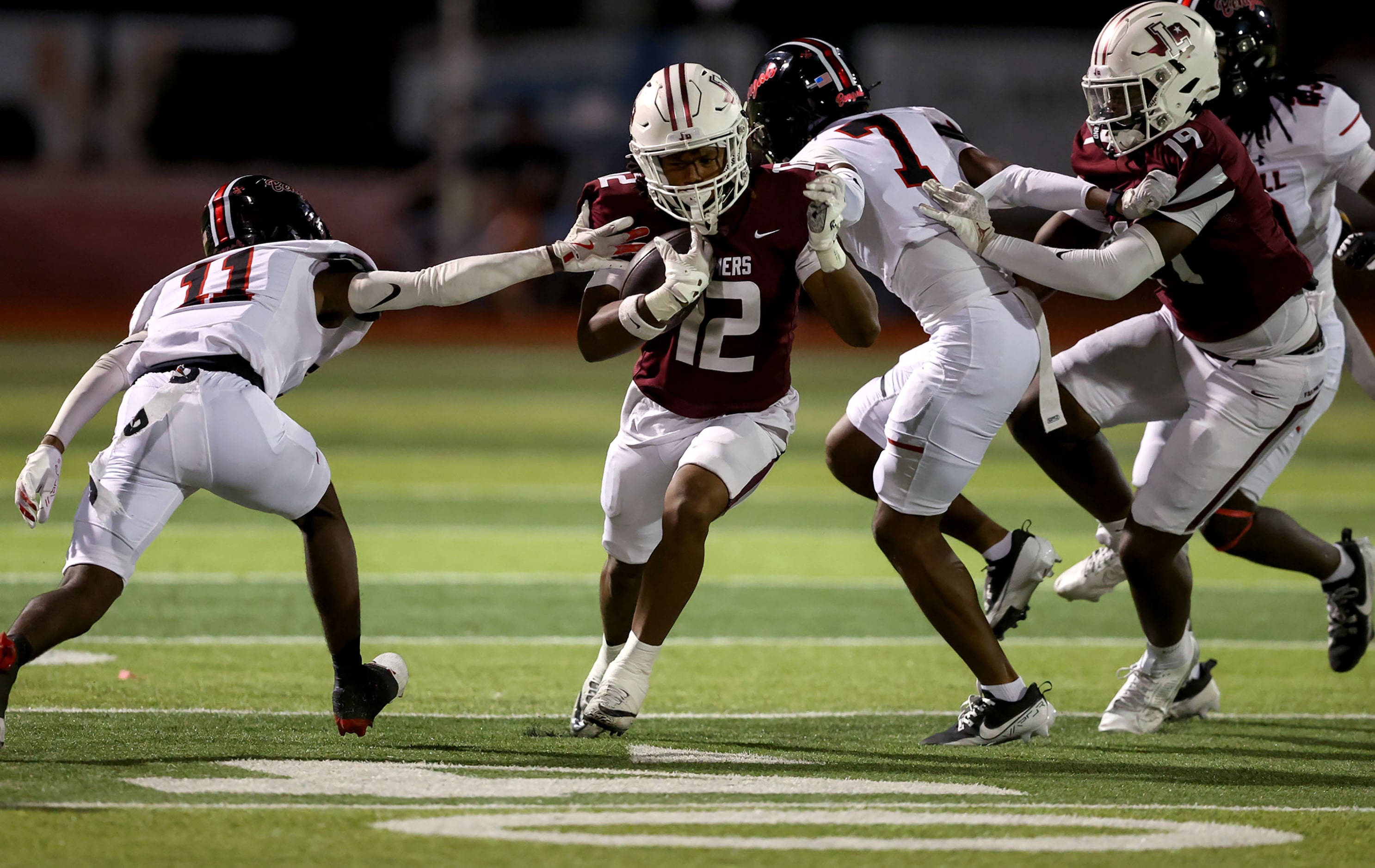 Lewisville wide receiver Derrick Martin (12) runs past Denton Braswell cornerback Patrick...