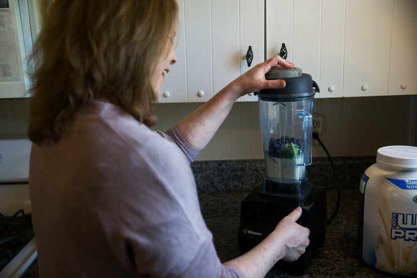 Author Kim Horner makes a smoothie with kale, blueberries, vanilla protein powder and soy...