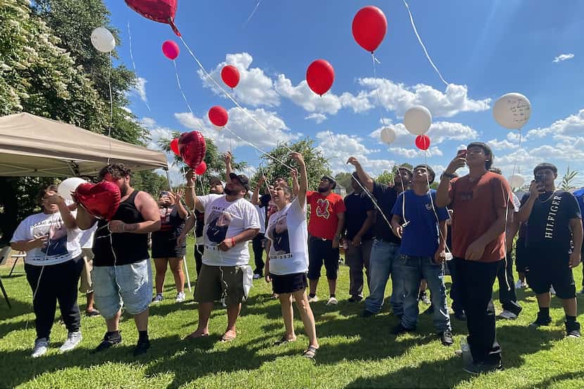 Family and friends release balloons in memory of Isaac Aguirre at Grove Hill Memorial...