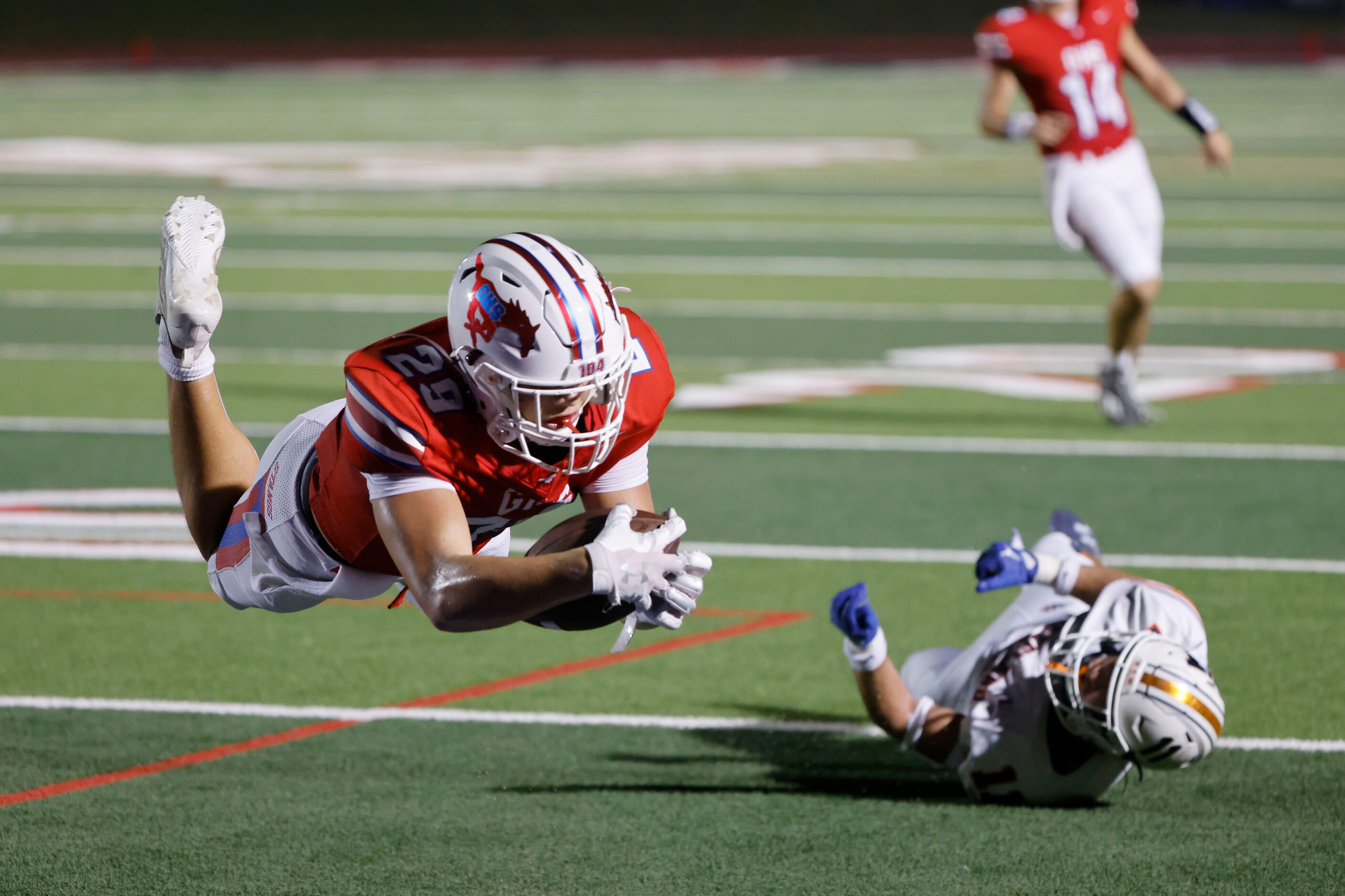 Grapevine’s Ian Hatton (29), leaps into the end zone to score a touchdown against Frisco...