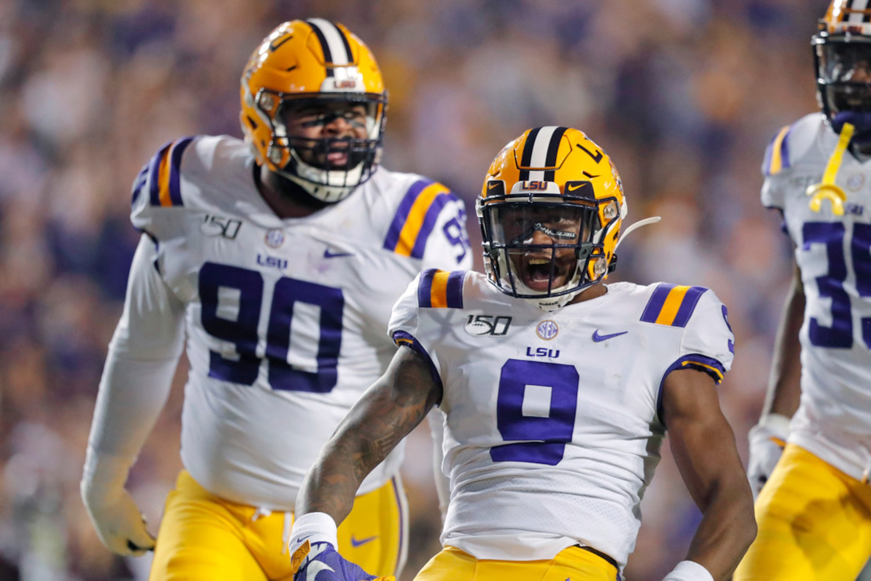 LSU safety Marcel Brooks (9) and defensive lineman Rashard Lawrence (90) celebrate a sack...