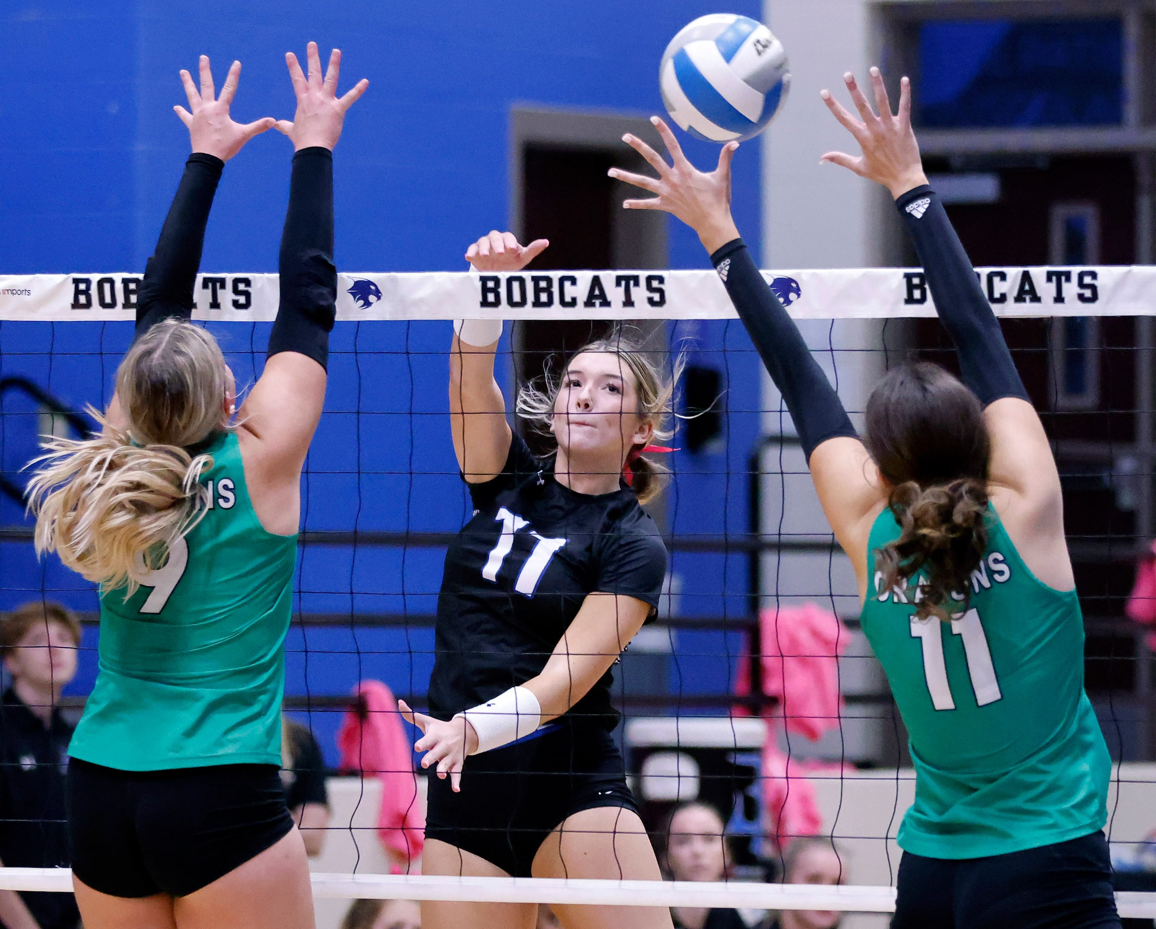 Trophy Club Byron Nelson outside hitter Morgan Inemer (11) spikes the ball between the...