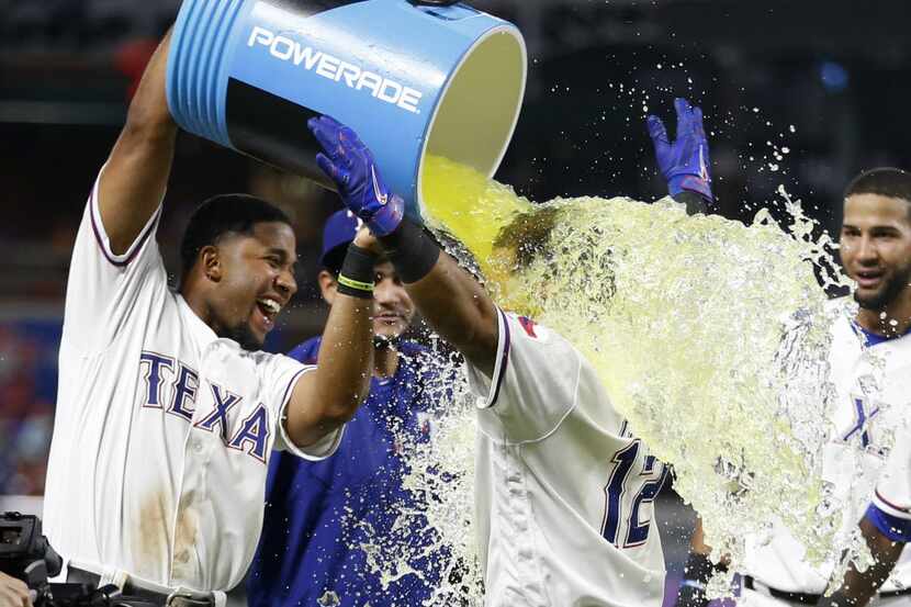 Texas Rangers shortstop Elvis Andrus (1) pours Powerade on Texas Rangers second baseman...