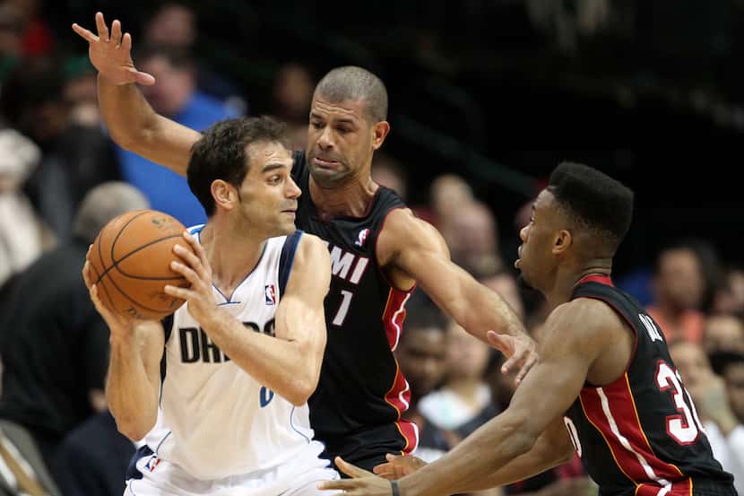 Dallas Mavericks point guard Jose Calderon (8) is double  teamed by Miami Heat small forward...