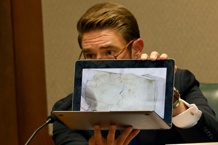 Rep. Jeff Leach shows an image of a rug with blood stain of death row inmate Robert...