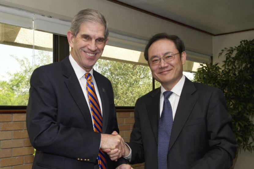 UTA president James Spaniolo (left) and Fangchun Yang, vice president at Beijing University...