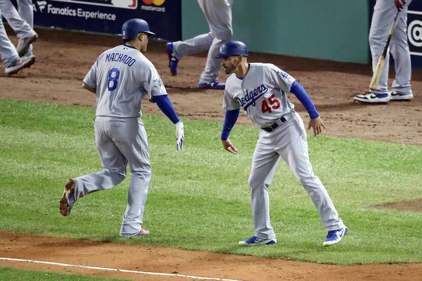 BOSTON, MA - OCTOBER 23:  Manny Machado #8 of the Los Angeles Dodgers is congratulated by...