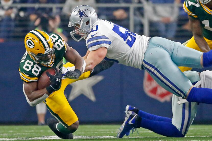 Green Bay Packers running back Ty Montgomery (88) is tackled by Dallas Cowboys outside...