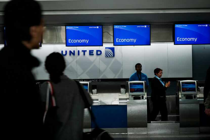 FILE -- Commuters at United Airlinesâ check-in section at LaGuardia Airport in New York,...