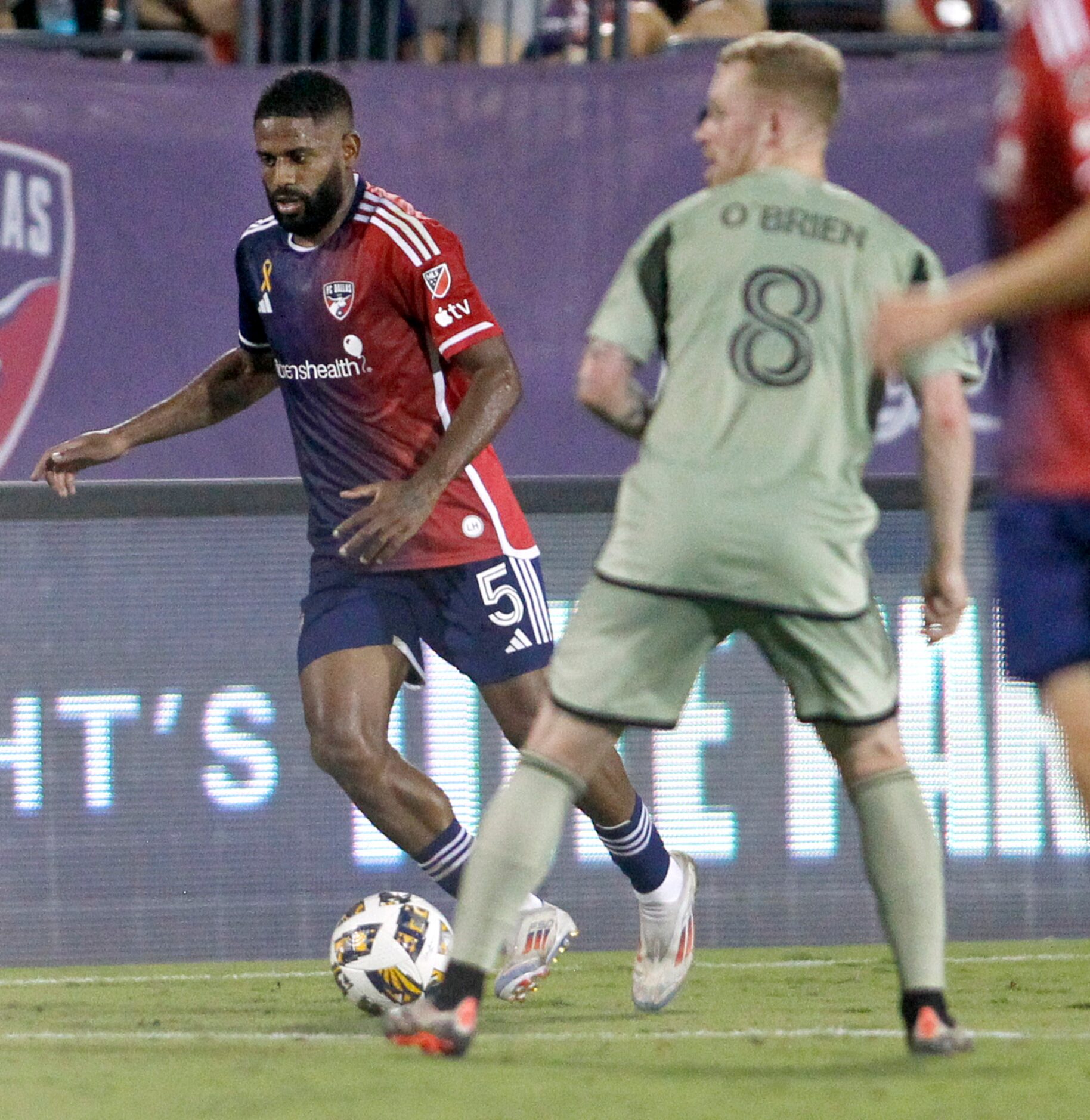 FC Dallas midfielder Ruan (5), left, controls the ball past LAFC midfielder Lewis O'Brien...