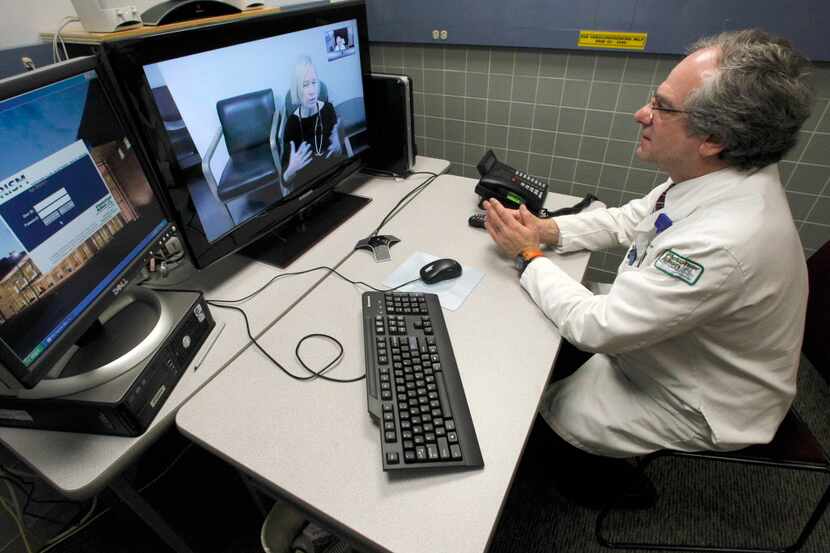 FILE - In this Thursday, Dec. 20, 2012 file photo, Dr. Terry Rabinowitz, right, talks with...