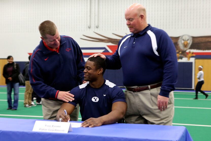 Allen head football coach Tom Westerberg and Offensive line coach Mike Carter congratulate...