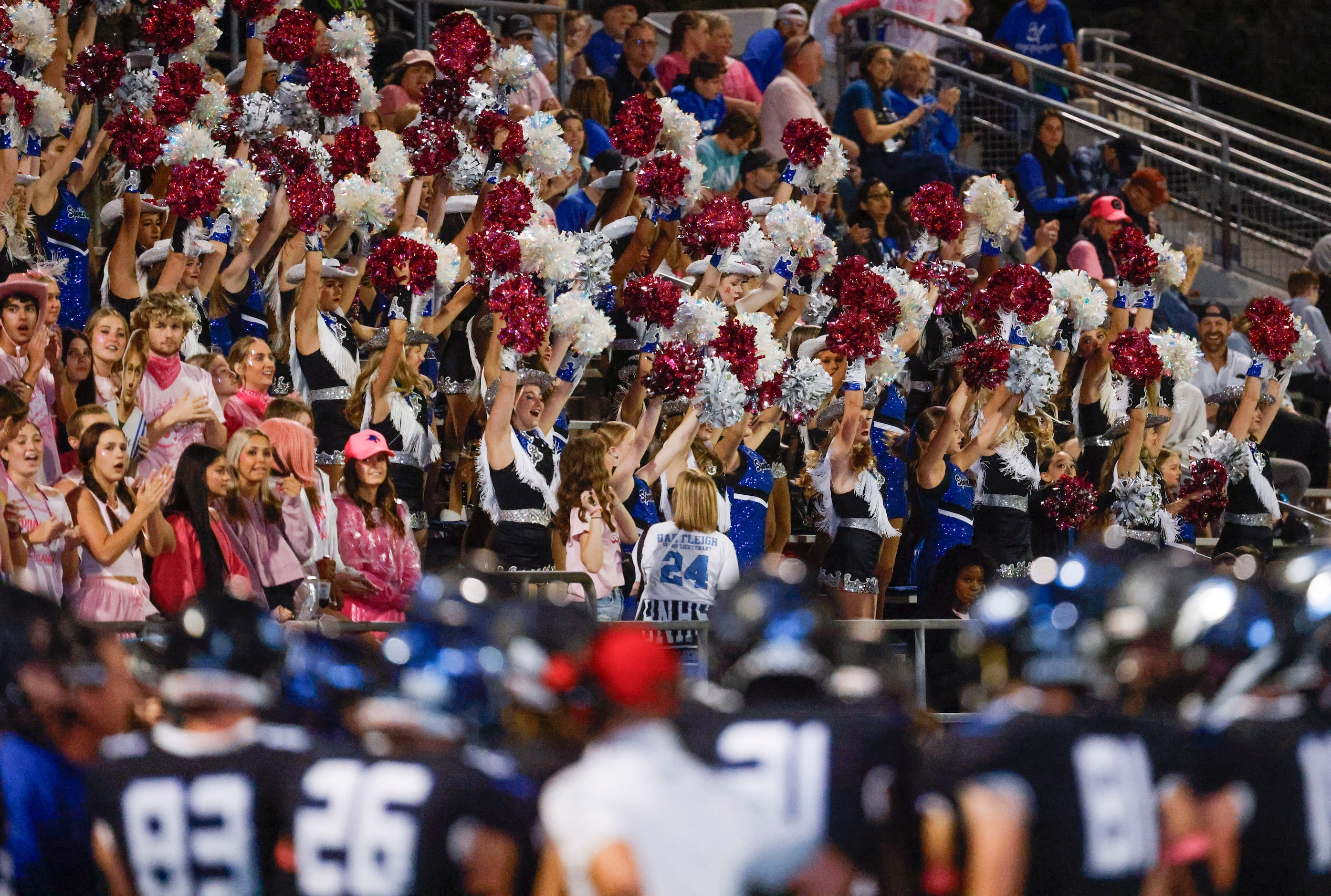 Byron Nelson high school drill team cheer from the stands during the first half of a...