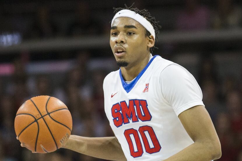 Southern Methodist Mustangs forward Ben Moore (00) looks for a pass during the first half of...