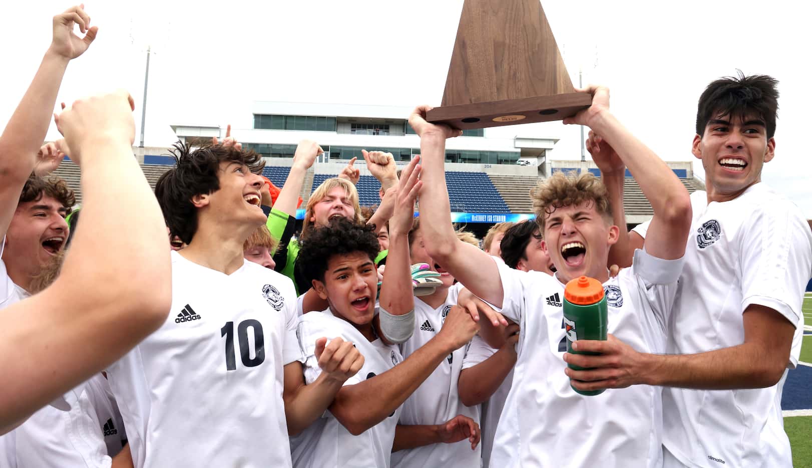 Flower Mound midfielder Colby Deleeuw (23), second from right, lets out an emphatic yell as...