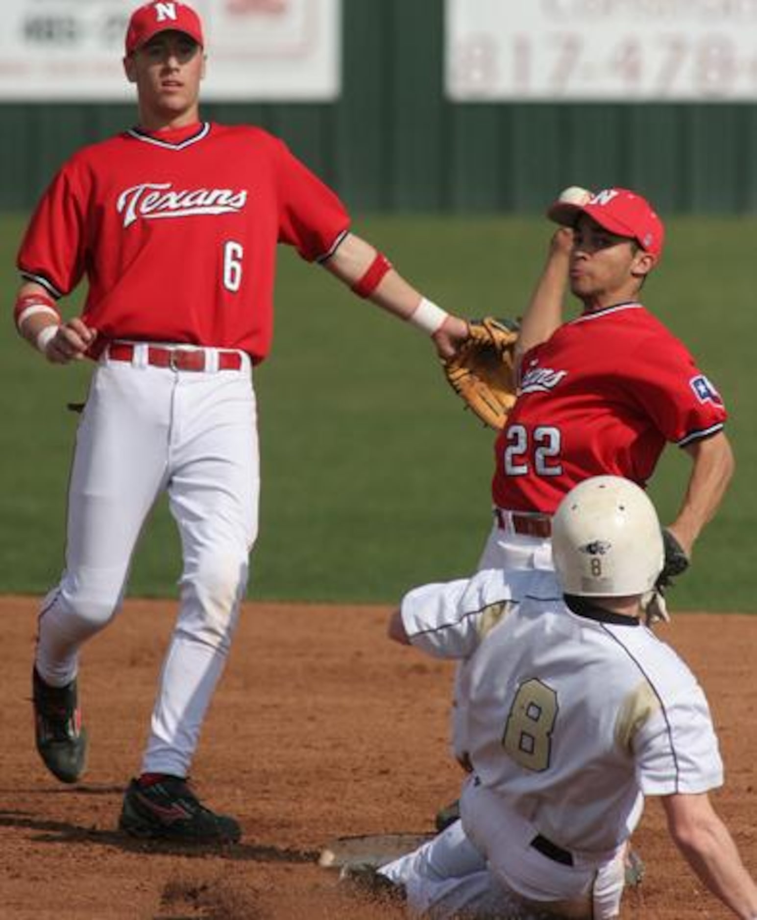 Justin Northwest second baseman Aaron Kohler (22) forces out Plano East's Tyler Wylie (8)...