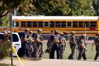 Tactical officers cleared the scene following a shooting inside Mansfield Timberview High...