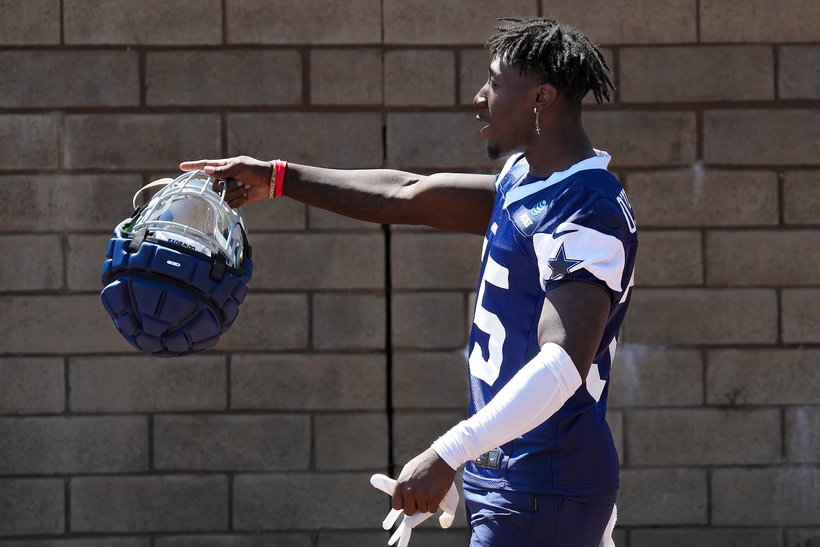 Dallas Cowboys linebacker DeMarvion Overshown motions to fans as he takes the field for a...