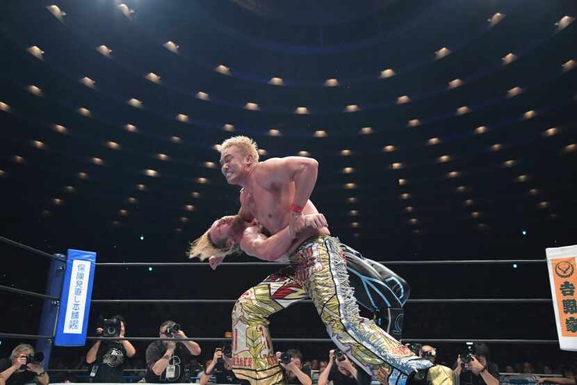 Professional wrestlers Kazuchika Okada (top, front) and Kenny Omega face off in Japan's...