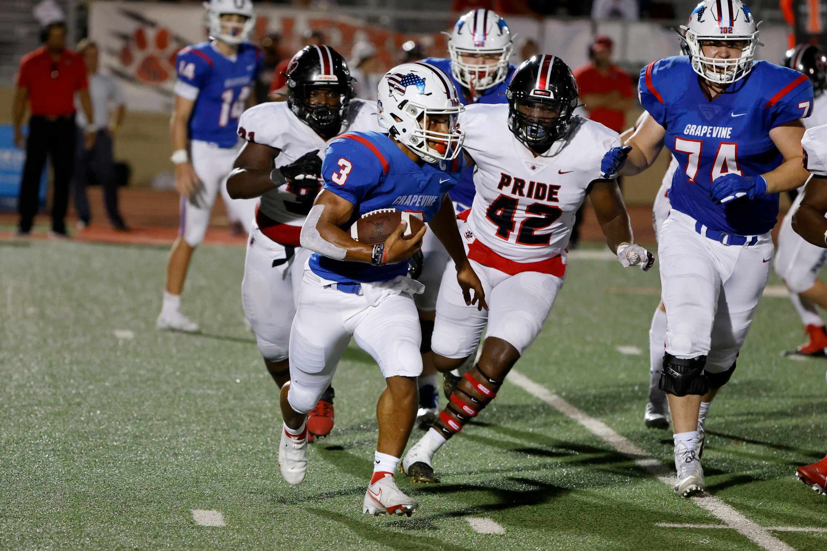 Grapevine running back Caleb Texada (3) tries to get away from Colleyville Heritage defender...