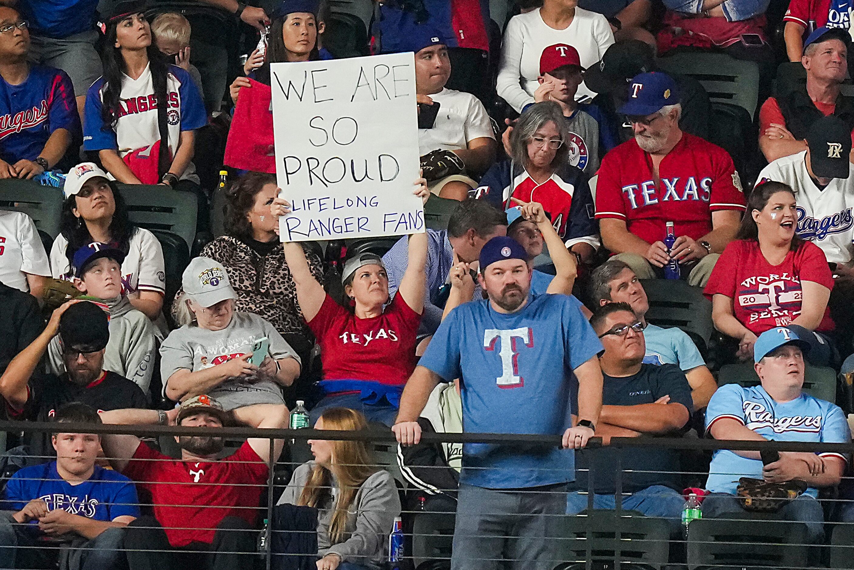 Show their support for the Texas Rangers during the ninth inning in Game 2 of the World...