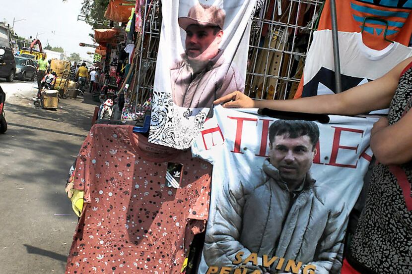 A vendor shows a t-shirt with the face of Joaquin "El Chapo" Guzman Loera for sale on July...