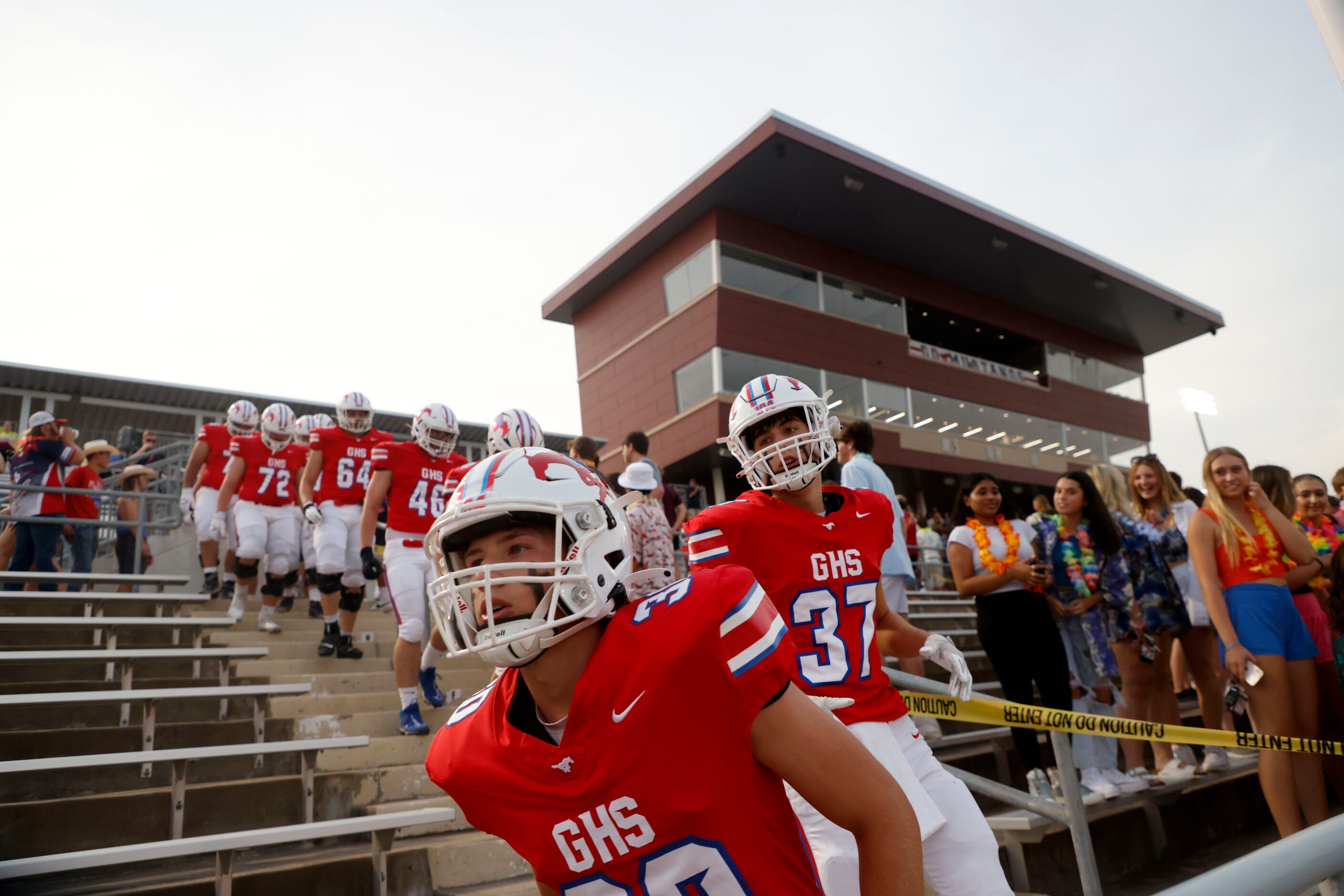 Grapevine players Hayden Rhoades (30) and Maddox Stanley (37) run onto the field prior to...