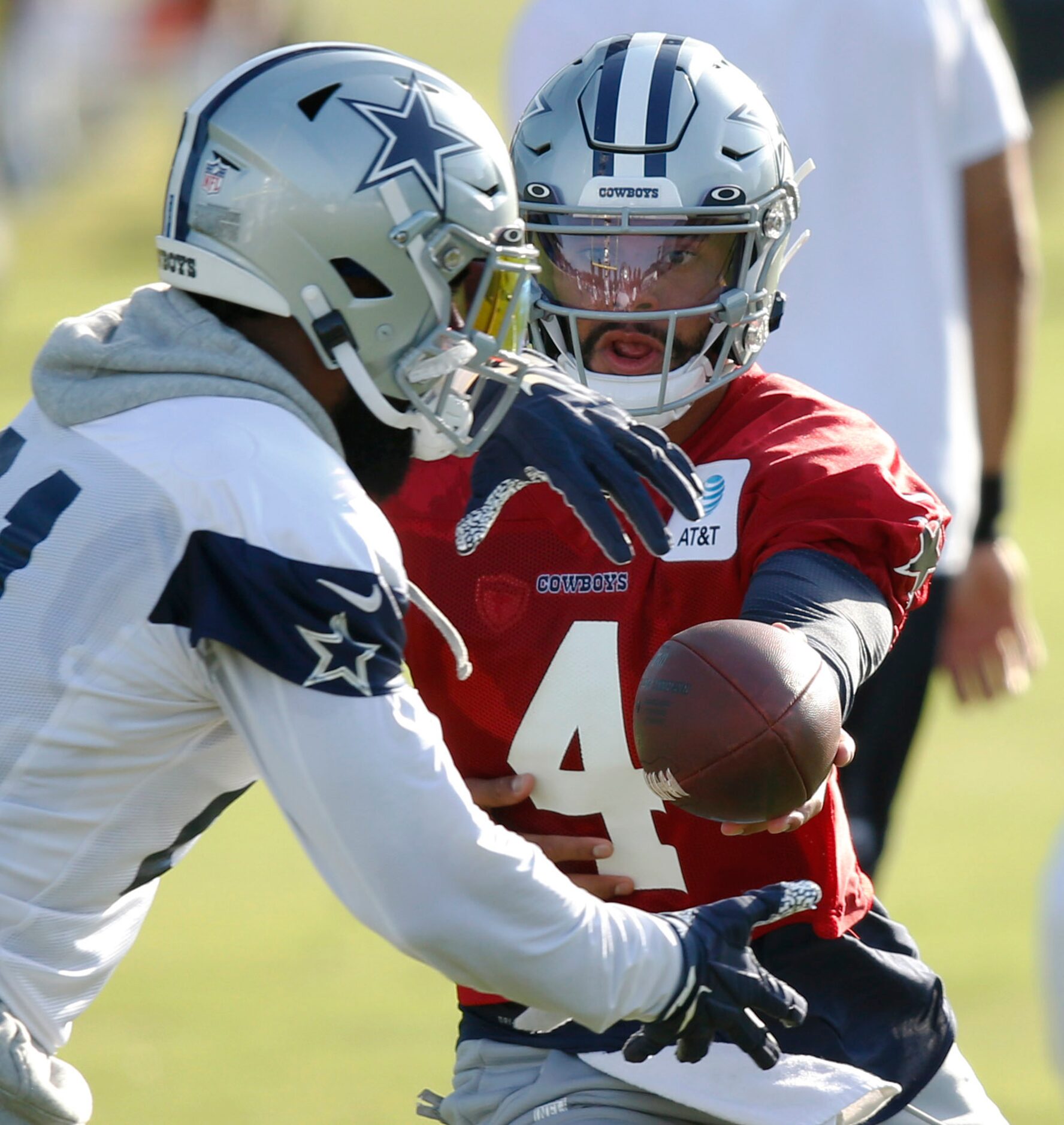 Dallas Cowboys quarterback Dak Prescott (4) hands the ball off to Dallas Cowboys running...