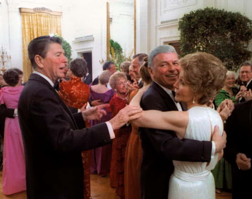 
President Ronald Reagan tries to cut in on a dance between Frank Sinatra and first lady...
