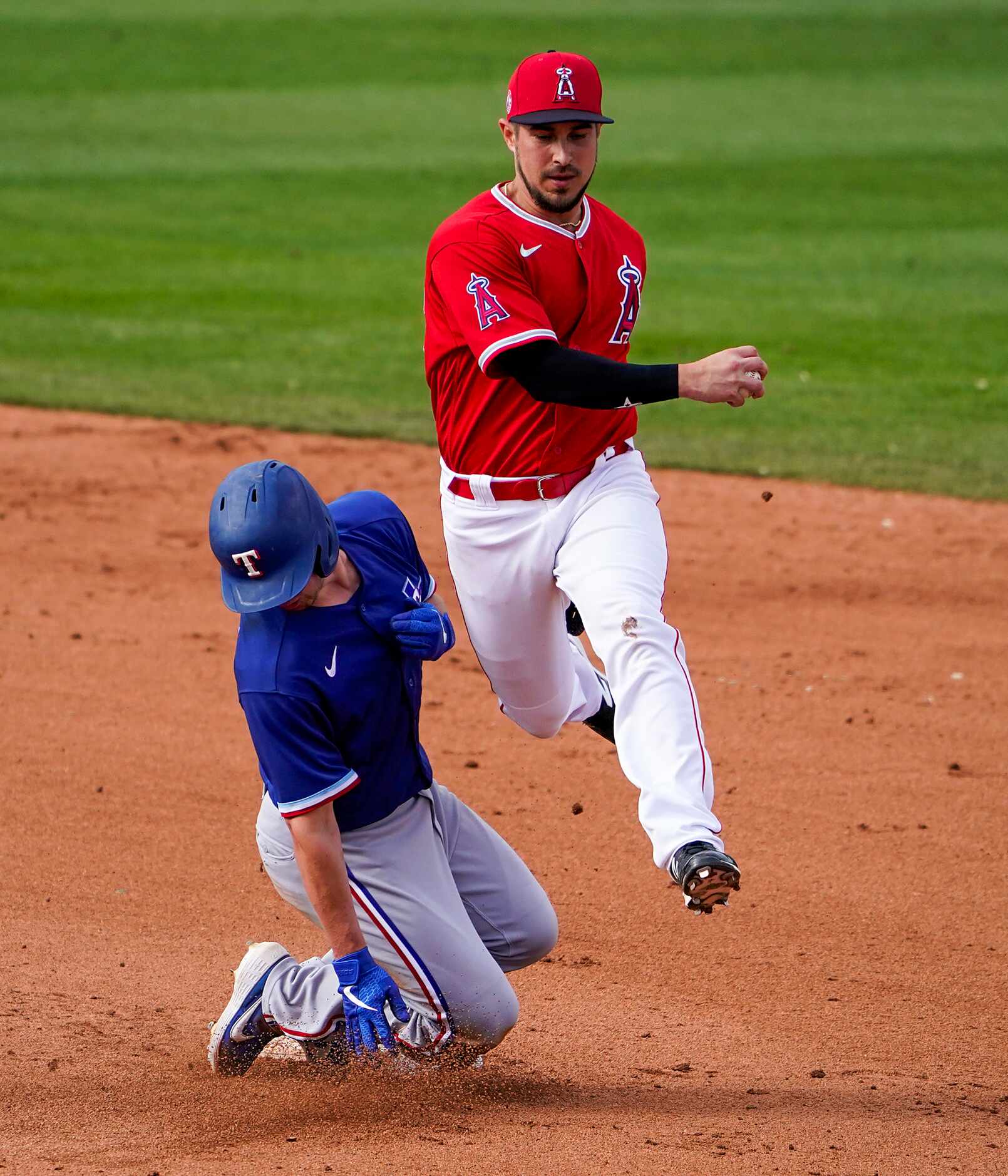 Texas Rangers baserunner Nick Solak avoids a collision with Los Angeles Angels shortstop...