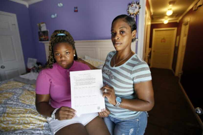 
Natod'Ja Washington, left, 16, poses for a photo with her mother Natasha Holloway in their...