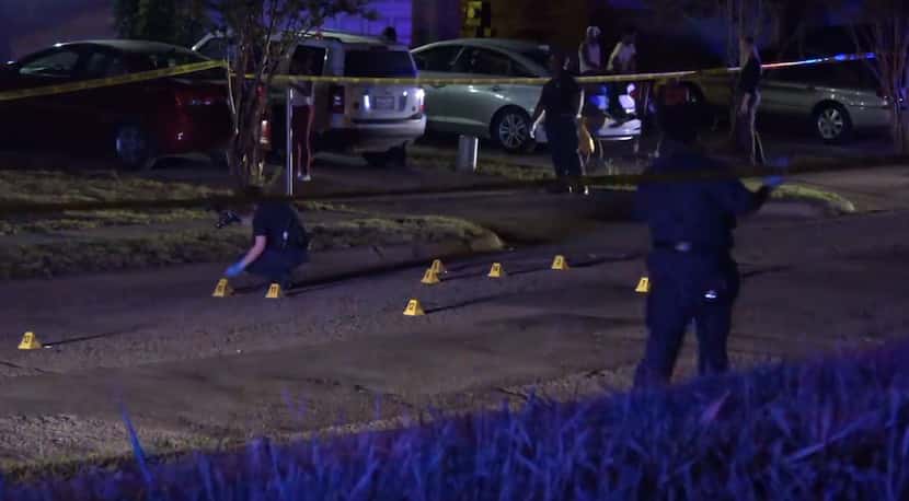Police collect evidence at the scene of a fatal shooting in southeast Dallas.