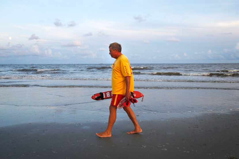 Lifeguard Bill Bower patrols his area along the beach in Galveston.