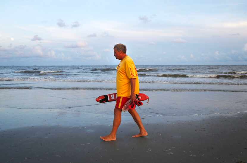 Lifeguard Bill Bower patrols his area along the beach in Galveston.