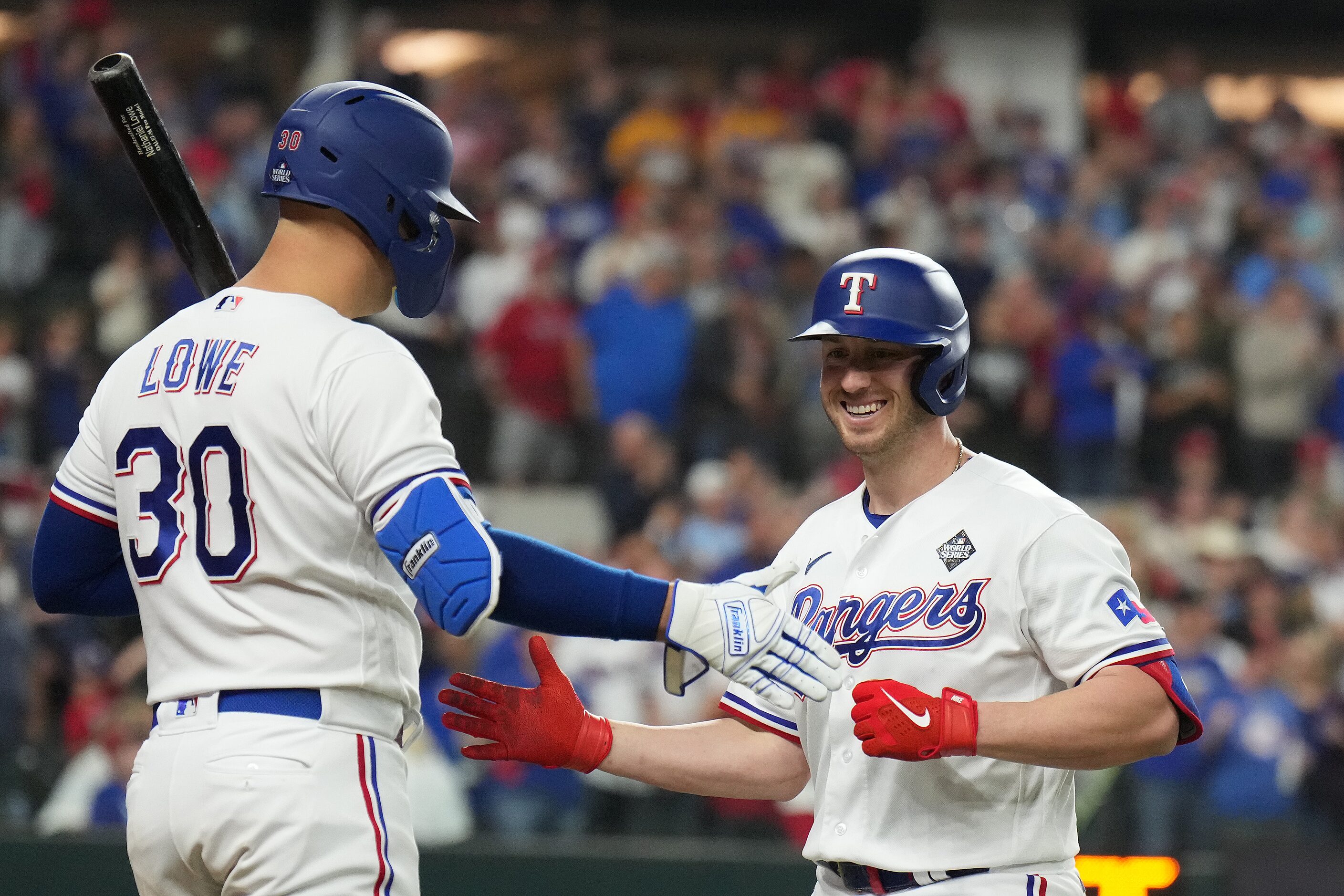 Texas Rangers designated hitter Mitch Garver, right, celebrates with Nathaniel Lowe after...