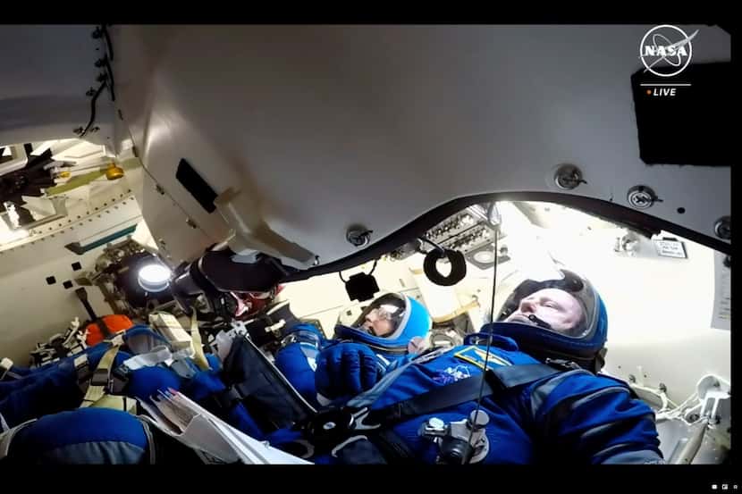 NASA astronauts Butch Wilmore, right and Suni Williams wait for liftoff inside the Boeing...