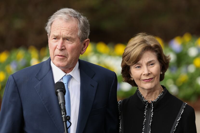 Former President George W. Bush -- seen here in 2018 with his wife, Laura -- is offering to...